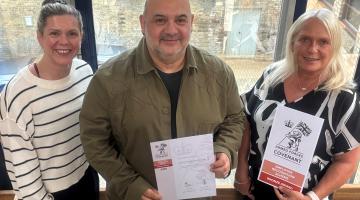 Housing team with employer recognition scheme documentation 