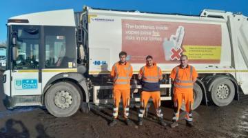 Waste lorry with crew members 